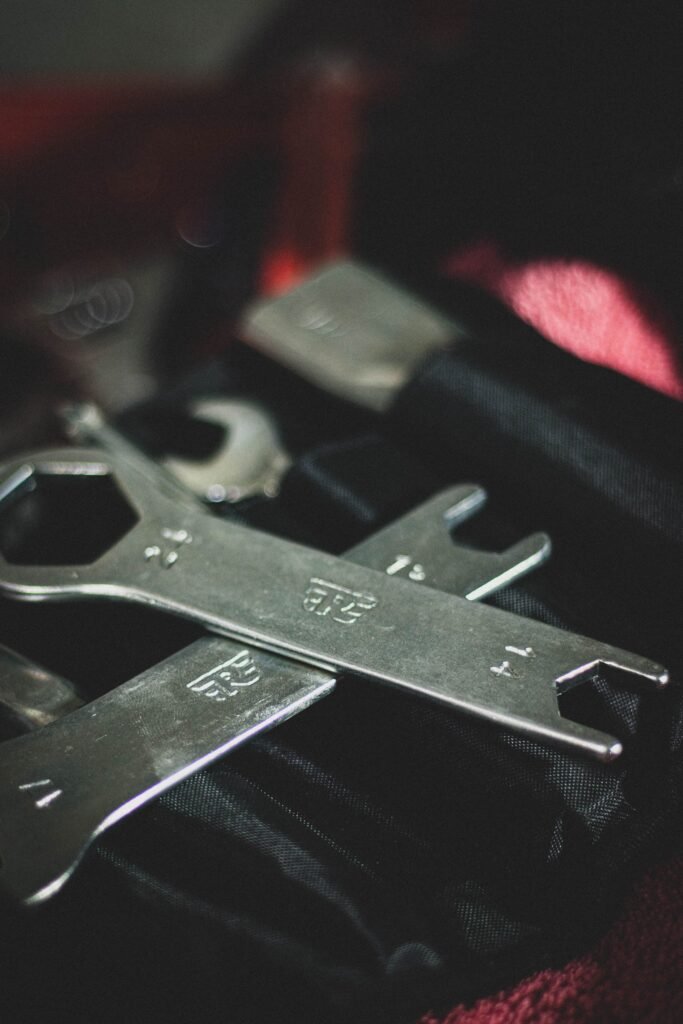 Detailed close-up of metallic wrenches in a black tool case, ideal for repair or mechanical themes.